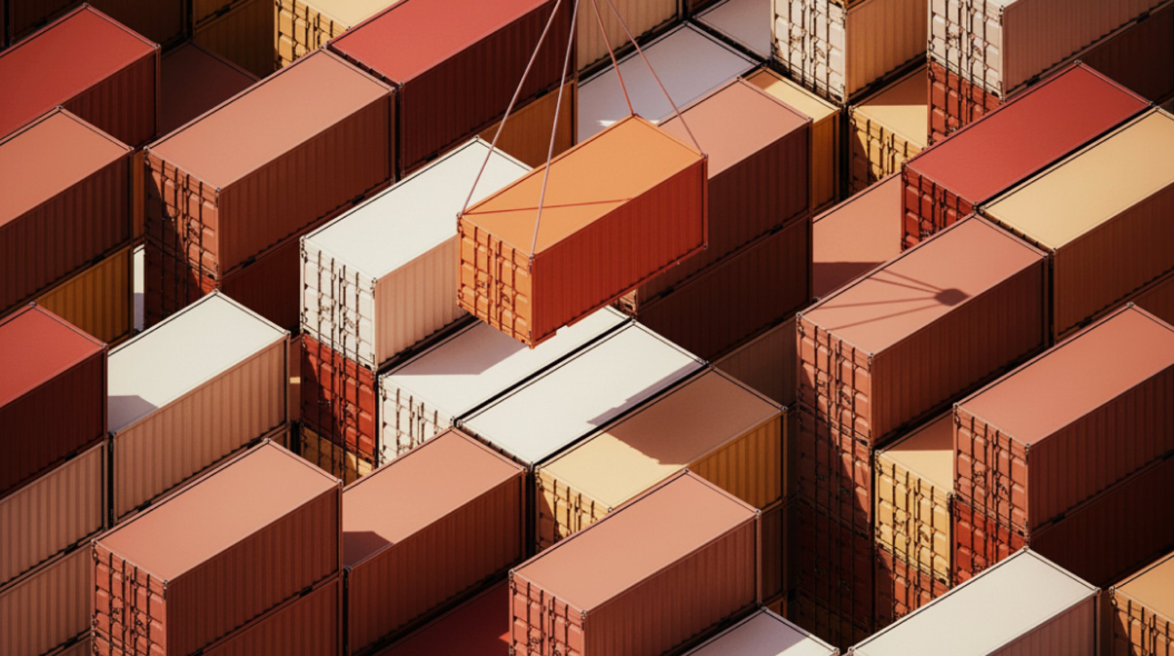 A crane lifting an orange container over a yard of stacked containers